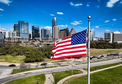 American Flag On Perfect Flag Pole Flying Patriotic Flag In Front Of The Austin Texas USA Skyline Cityscape Over A Capital City