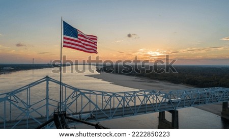 American flag on top of the old highway 80 bridge crossing over the Mississippi River at Vicksburg, MS.