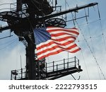 american flag on a warship waving in the wind