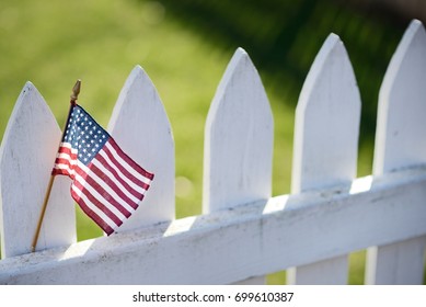 American Flag On White Picket Fence For US Holidays Like Memorial Or Labor Day.