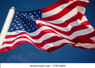 American Flag Over Blue Sky Background