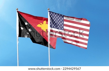American flag and Papua New Guinea flag on cloudy sky. waving in the sky