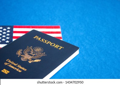 American flag and passport on blue background. Independence Day concept, 4th of July. 