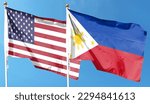 American flag and Philippine flag on cloudy sky. waving in the sky