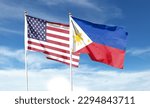 American flag and Philippine flag on cloudy sky. waving in the sky