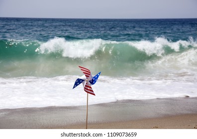 American Flag Pin Wheel On The Beach. 