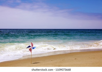 American Flag Pin Wheel On The Beach. 