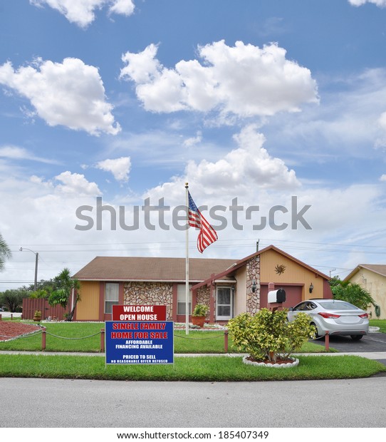 American Flag pole Open House Welcome Real Estate
For Sale Sign Suburban Home Residential neighborhood USA blue sky
clouds