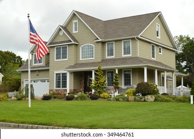 American Flag Pole Suburban McMansion Style Home Overcast Cloudy Day Residential Neighborhood USA