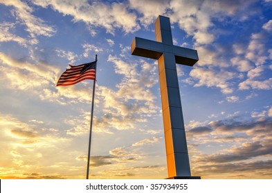 American Flag And Religious Cross At Sunset