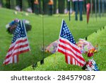 American Flag sits next to a traveling Vietnam memorial wall with the flags reflection.