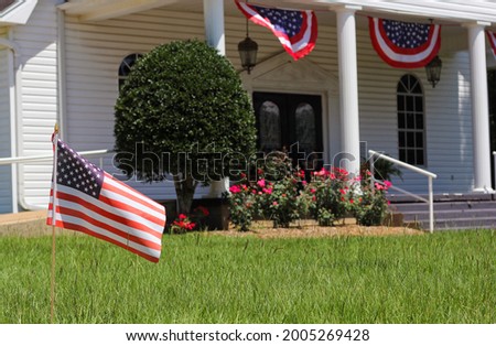 American Flag With Small Rural Church in Background Shallow DOF Focus on Flag