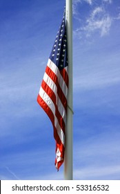 American Flag Takes A Rest As The Wind Calms Down Against The Dark Blue Summer Sky In The Background.