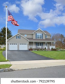 American Flag Tan Suburban McMansion Home Blue Sky Clouds USA