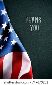 an american flag and the text thank you against a dark green background