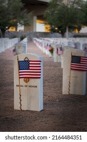 An American Flag Waves Over A Medal Of Honor Grave At A National Cemetery In West Texas.