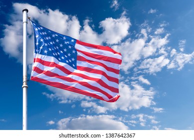 American Flag waving against blue Sky, USA Flag waving as Background