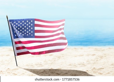 American Flag Waving In The Air On The Beach. Happy Labor Day