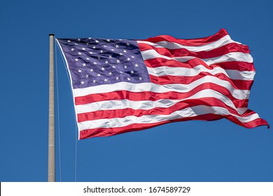 American flag waving in blue sky. Memorial Day