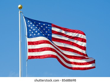 American Flag Waving In Blue Sky