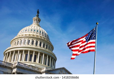 American flag waving with the Capitol Hill in the background - Shutterstock ID 1418358686