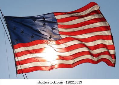 American Flag Waving In Front Of Sun Close Up