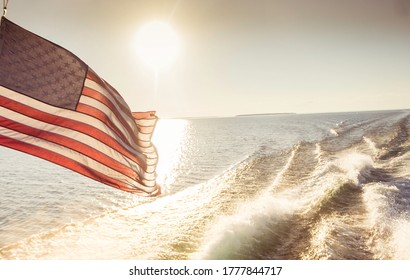 American Flag Waving in the Wind While on the Water and Under the Sunset - Shutterstock ID 1777844717