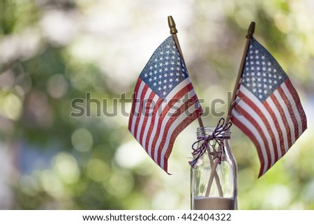 American flags with bokeh green background. July 4th celebration.