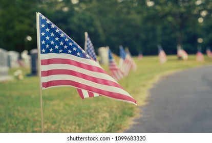 American flags displayed at a cemetery on Memorial Day. Vintage tone.