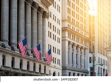 American flags flying in front of the historic buildings of Wall Street in the financial district of Manhattan, New York City NYC