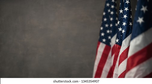 American flags over gray wall, 4th of july panoramic background with copy space