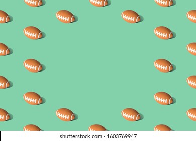 American football ball pattern on green background minimal creative sport concept. Space for copy.