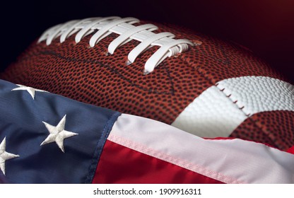 American Football Ball And USA Flag. Sport Game. Super Bowl In US. Football Ball Close Up Macro Photography With Copy Space.