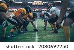 American Football Championship. Teams Ready: Professional Players, Aggressive Face-off, Ready for Pushing, Tackling. Competition Full of Brutal Energy, Power. Stadium Shot with Dramatic Light