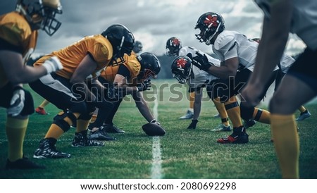 American Football Championship. Teams Ready: Professional Players, Aggressive Face-off, Ready for Pushing, Tackling. Competition Full of Brutal Energy, Power. Shot with Dramatic Light