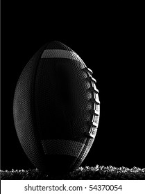 American Football Close Up At Night On Flood Lit Green Field (dark Mood) In Kicking Position Black And White