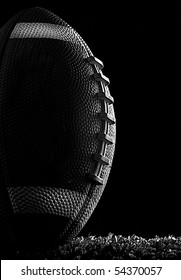 American Football Close Up At Night On Flood Lit Green Field (dark Mood) In Kicking Position Black And White