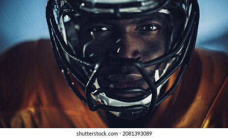 American Football: Close-up of Professional African-American Player Looking at Camera. Hero Athlete Ready to Win the Championship. Determination, Skill, Power. Dramatic Portrait Shot - Powered by Shutterstock