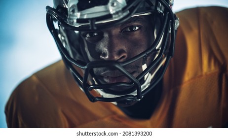 American Football: Close-up of Professional African-American Player Looking at Camera. Hero Athlete Ready to Win the Championship. Determination, Skill, Power. Dramatic Portrait Shot - Powered by Shutterstock