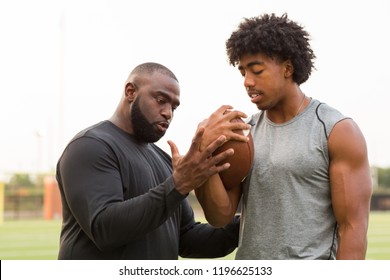 American Football Coach Training An Athlete.