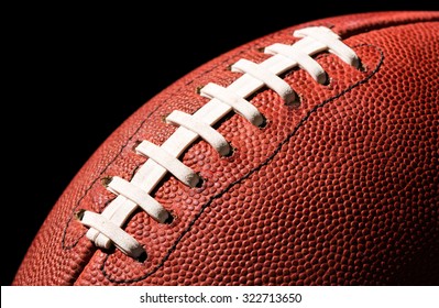 American Football Extreme Close Up On Laces Against Black Background