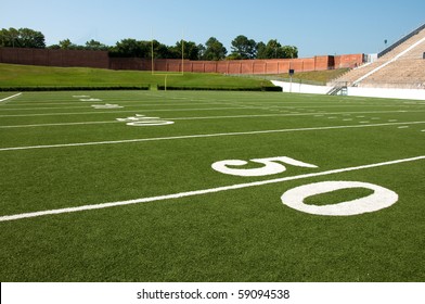 American Football Field With Goal Post In Background.