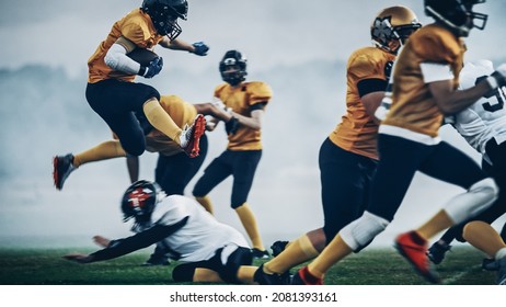 American Football Field Two Teams Compete: Successful Player Jumping Over Defense Running To Score Touchdown Points. Professional Athletes Compete For The Ball, Tackle, Fight For Championship Victory