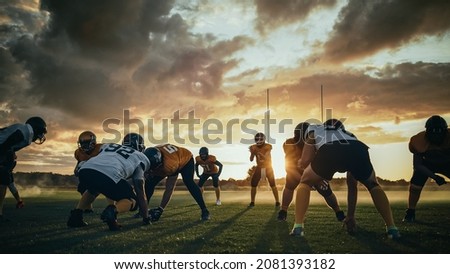 American Football Field Two Teams Compete: Players Pass and Run Attacking to Score Touchdown Points. Professional Athletes Fight for the Ball, Tackle. Dramatic Golden Hour Shot