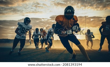 American Football Field Two Teams Compete: Players Pass and Run Attacking to Score Touchdown Points. Professional Athletes Fight for the Ball, Tackle. Golden Hour Sunset Shot