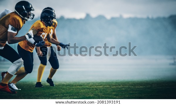 American Football Field Two\
Teams Compete: Players Pass and Run Attacking to Score Touchdown\
Points. Professional Athletes Compete for the Ball, Tackle, Fight\
for Victory.