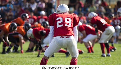 american football game with out of focus players in the background