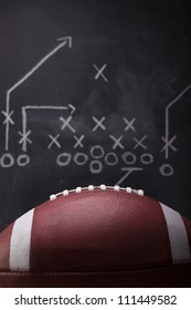 An American Football And A Hand Drawn Chalkboard Play.