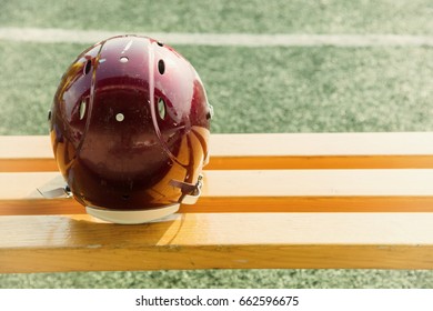 American Football Helmet On The Bench And Playing Field.