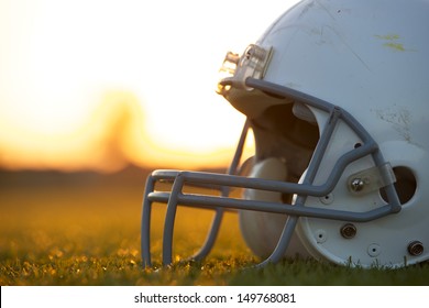 American Football Helmet On The Field At Sunset With Room For Copy